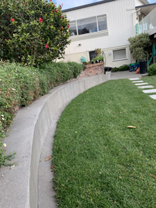 Concrete retaining wall formed and faced